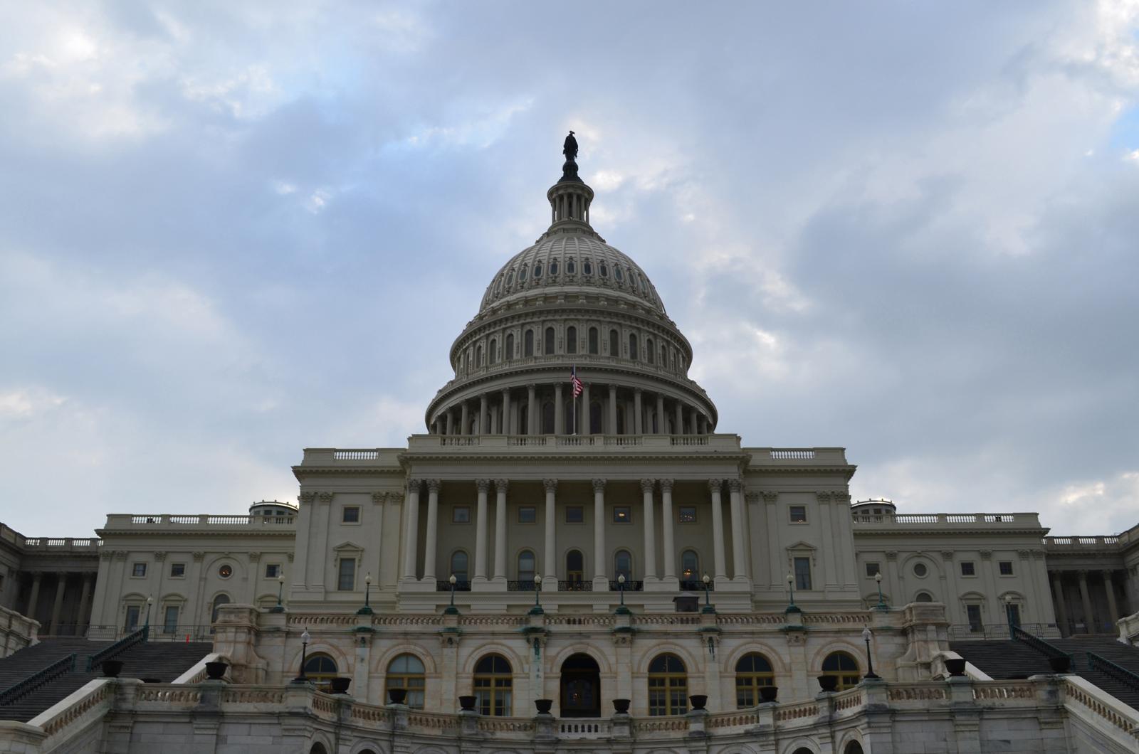 The west front of the U.S. Capitol, its dome under a cloudy sky